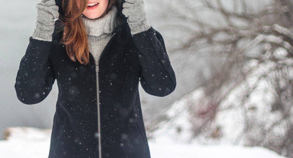 Frau im Schnee mit Winterjacke